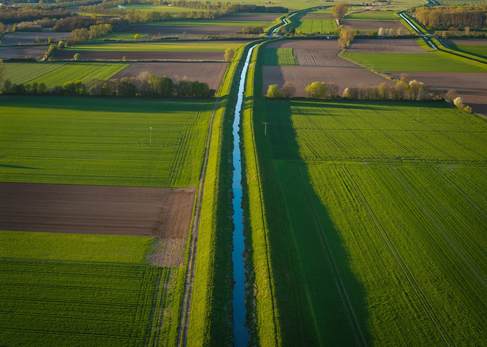 Aerial view of an irrigation canal running through farmland